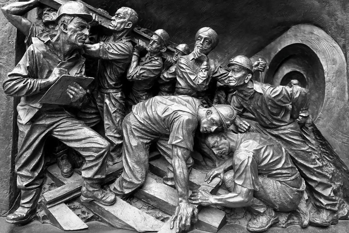 Young miners in muddy clothes working in an open pit, some holding basic tools, no safety equipment visible, working in harsh conditions under open sky, poverty and danger evident in their expressions