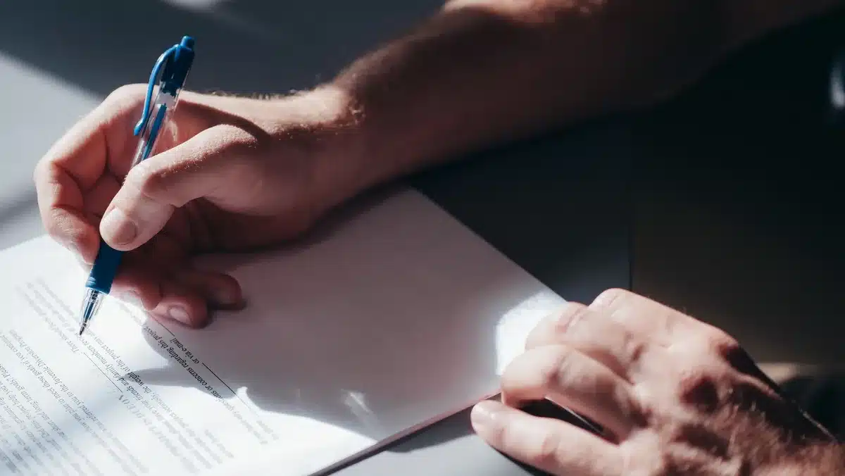 Stack of petition documents on table with signature pages visible
