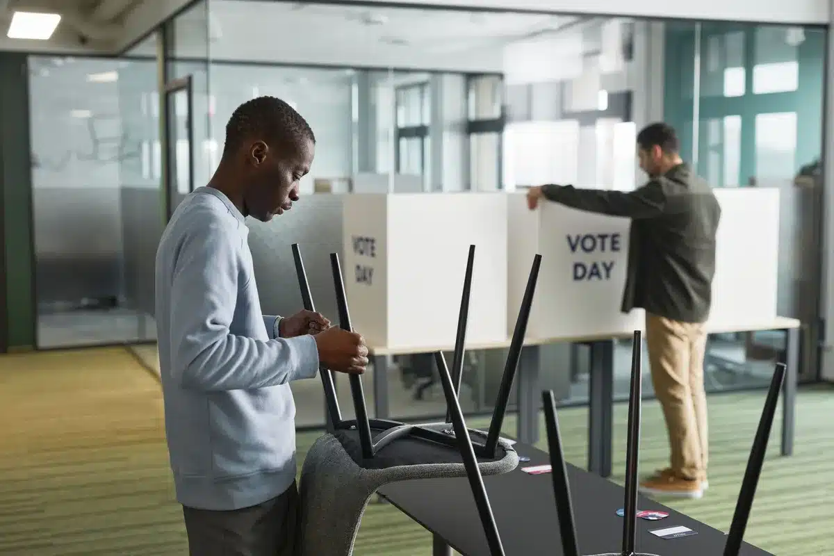 A voting booth interior with a ballot inside, soft focus background of a polling place, neutral lighting