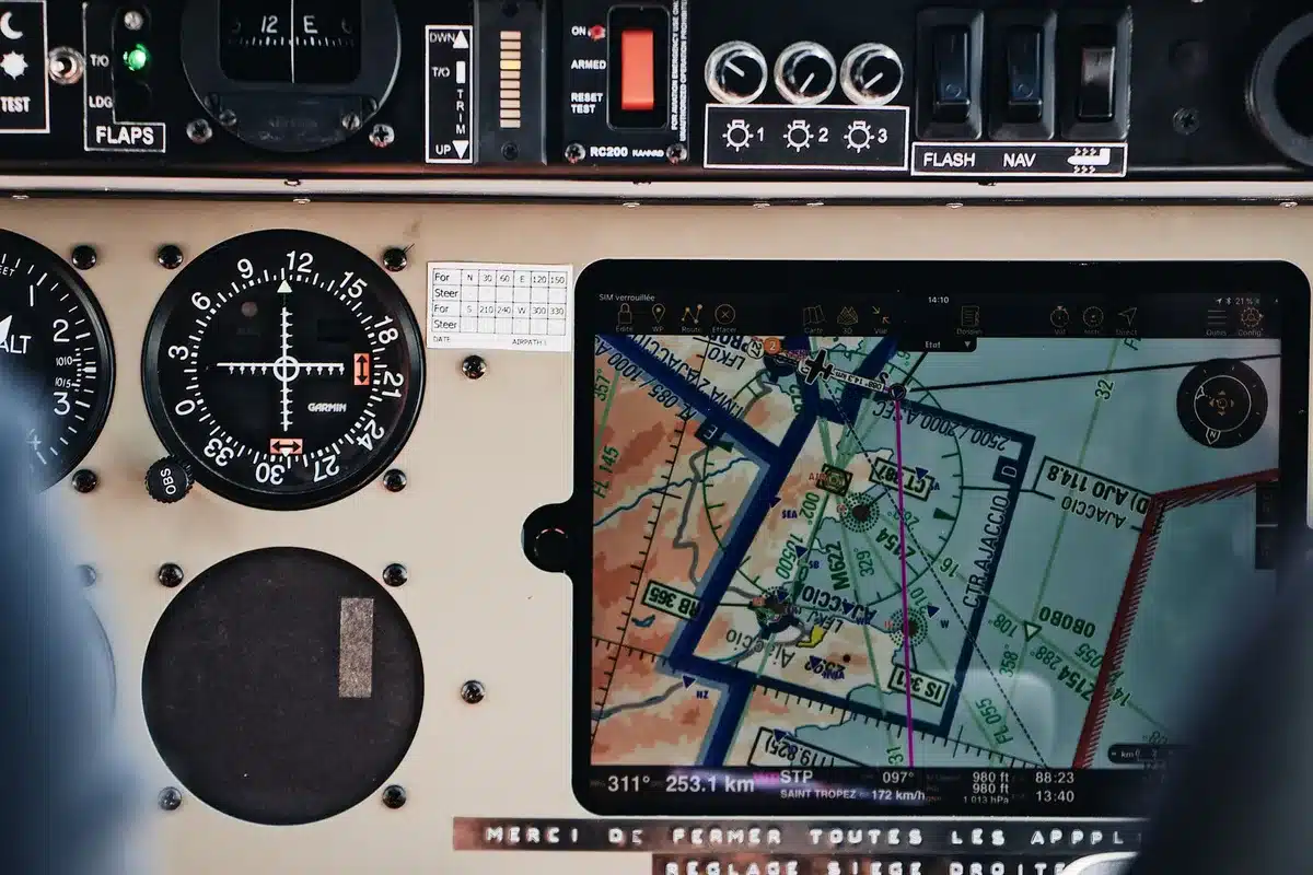 A radar screen display showing aircraft blips and altitude readouts, with one section of the screen dark or blank, emergency lighting casting a blue-green glow on the control room, technical equipment in soft focus behind