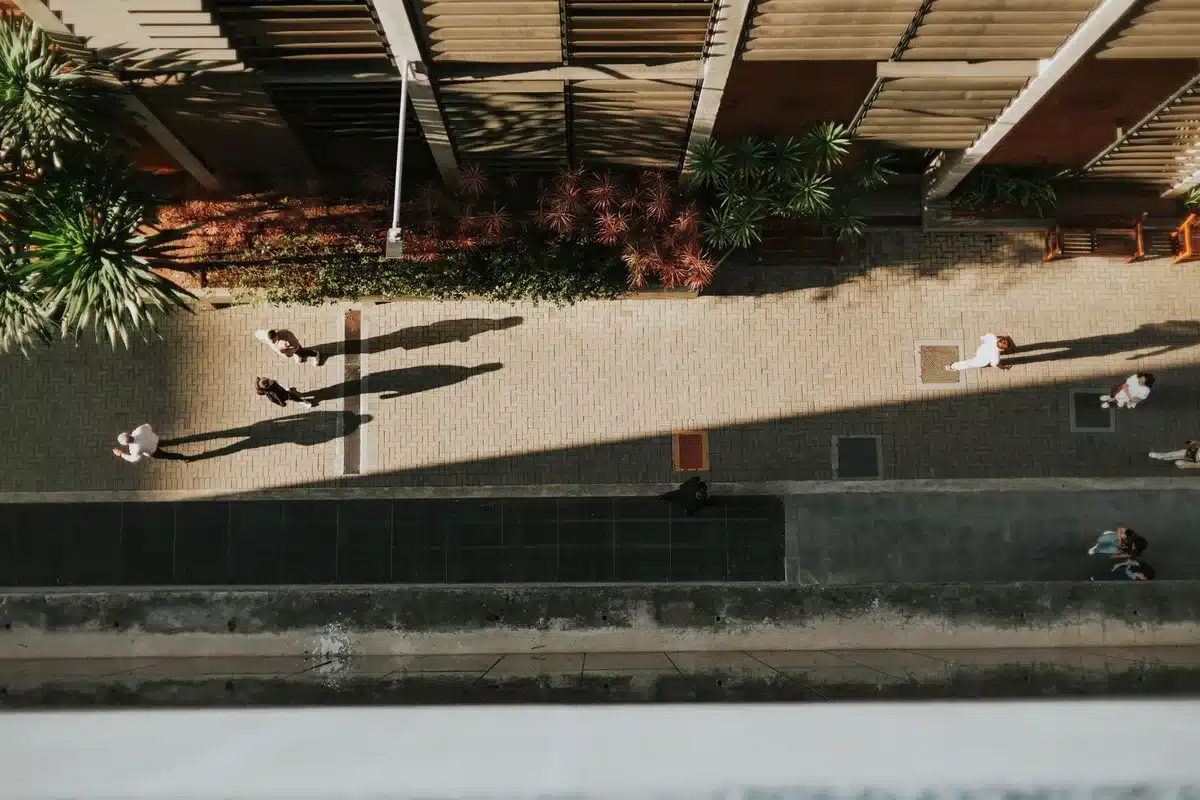 A government building entrance with shadows of people walking past, suggesting internal conflict and shifting dynamics within the administration