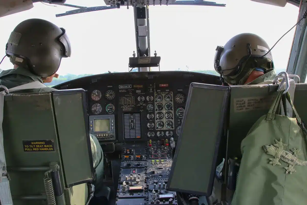Military command center with officers monitoring radar screens displaying missile trajectories, urgent activity, tension