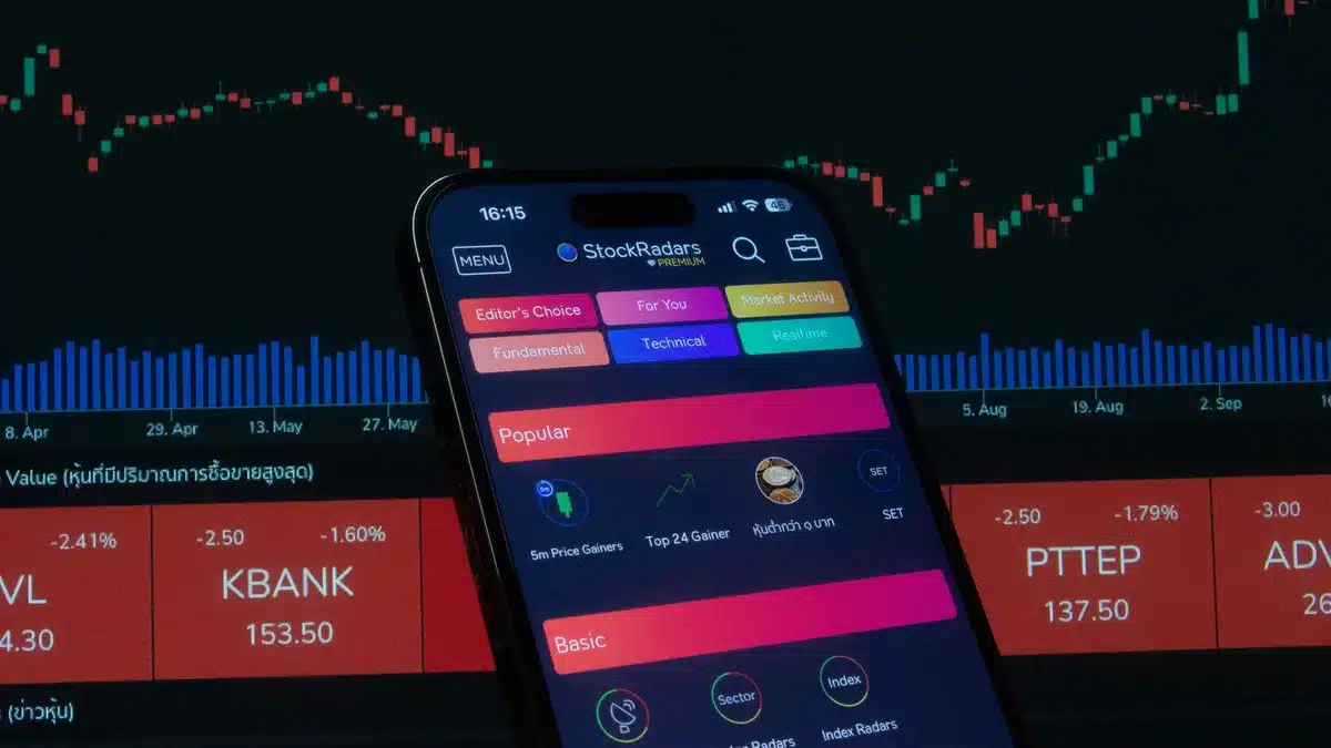 A modern stock trading floor with multiple screens displaying financial charts and data, traders monitoring market movements, focused lighting on glowing displays