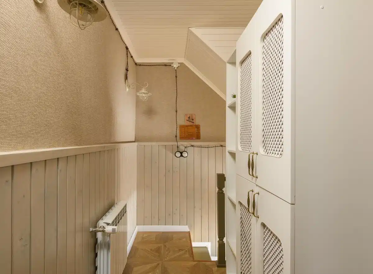 An empty White House corridor with formal portraits lining the walls, a single desk and chair visible through an open doorway, cool fluorescent lighting casting shadows, a sense of behind-the-scenes power and influence.