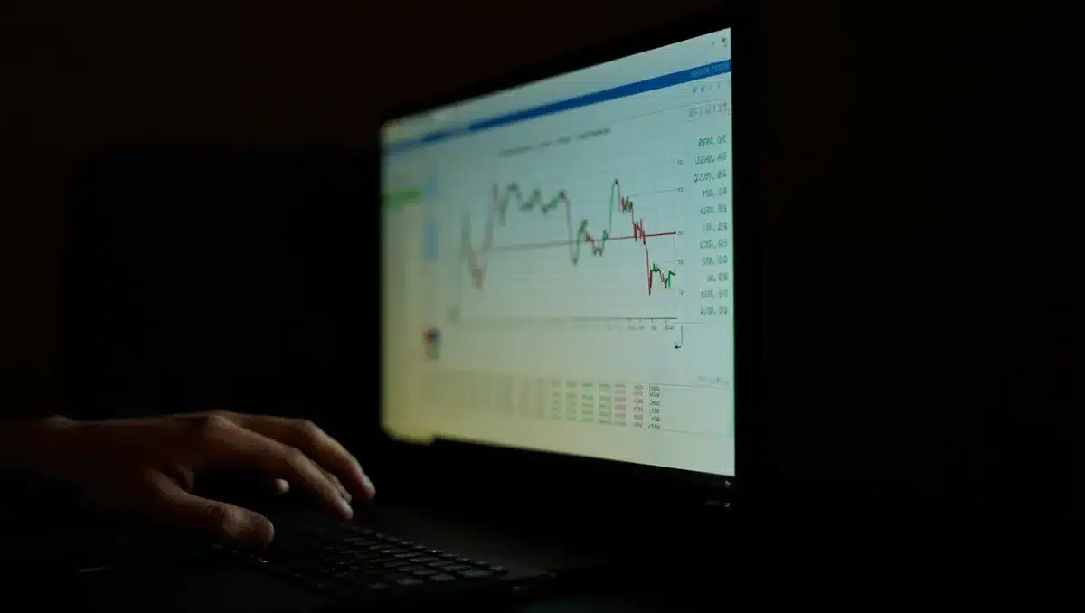 Stock market data on a glowing screen showing an upward trending line and green gains percentage | stock market trading screen