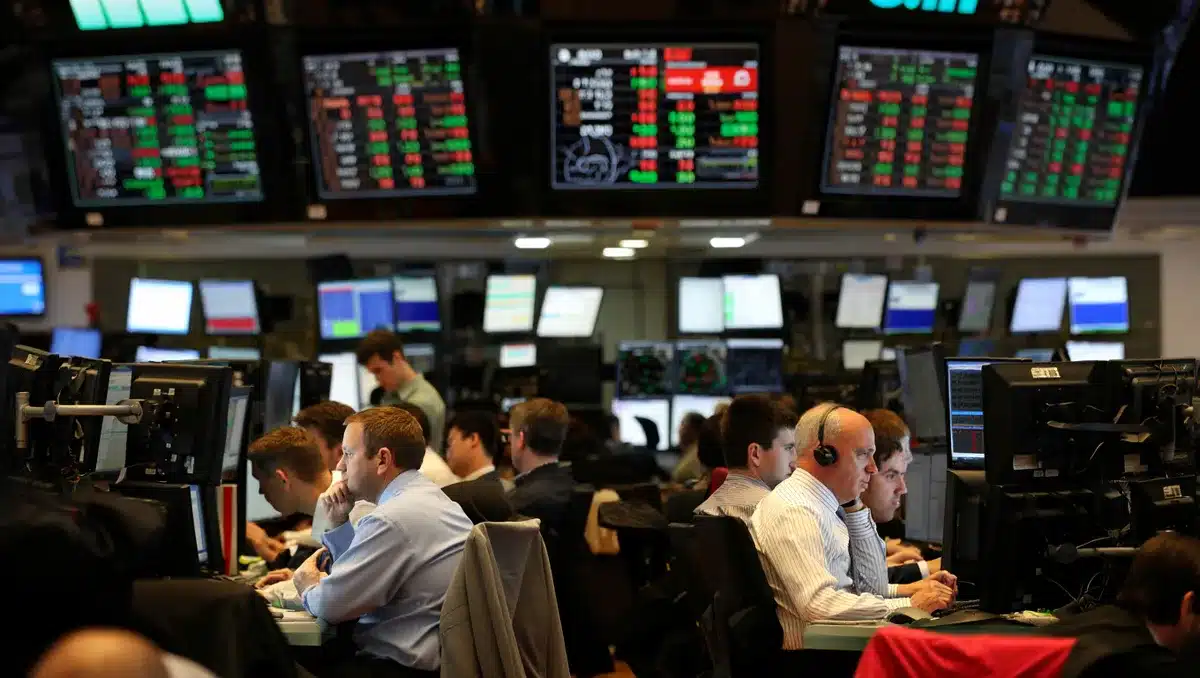 Stock market trading floor with multiple screens displaying real-time financial data and price tickers, traders monitoring earnings announcements, energy and focus visible | stock market earnings announcement