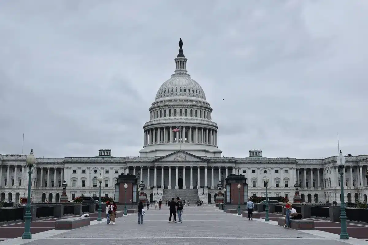 A Republican congressional delegation gathering in a formal Capitol Hill setting, members standing united at a podium, American flags in background, emphasizing party consolidation and political unity.