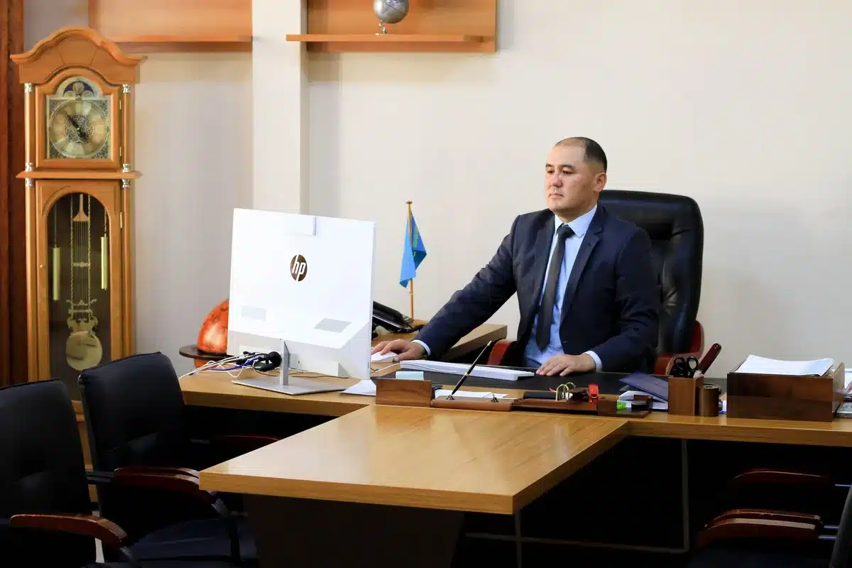 A Tehran meeting room with officials gathered around a table, formal documents and flags visible, fluorescent light casting shadows, tension and diplomacy in the air