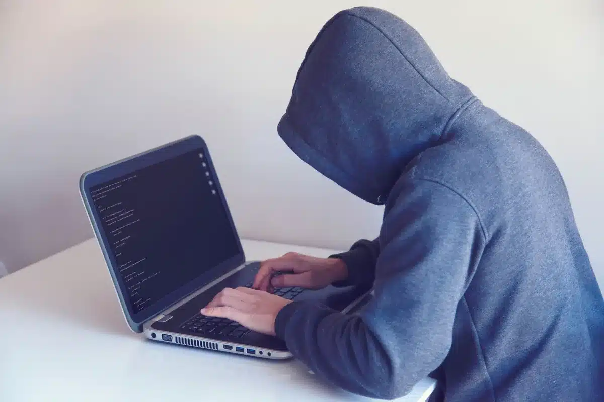 A laptop screen displaying an e-commerce checkout interface with multiple browser tabs and affiliate tracking code visible, representing the technical mechanism behind cookie stuffing fraud.