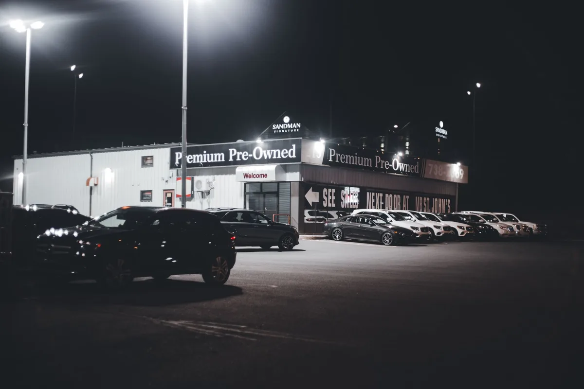 A 2027 Prius in the new Inked black color parked in modern showroom lighting, sleek profile emphasizing the hybrid sedan's contemporary styling.