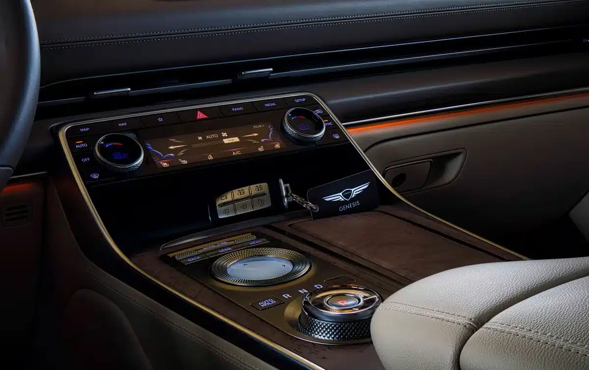 Driver and passenger silhouettes adjusting separate climate controls in a modern car interior, cool blue and warm orange zones visible on dual displays