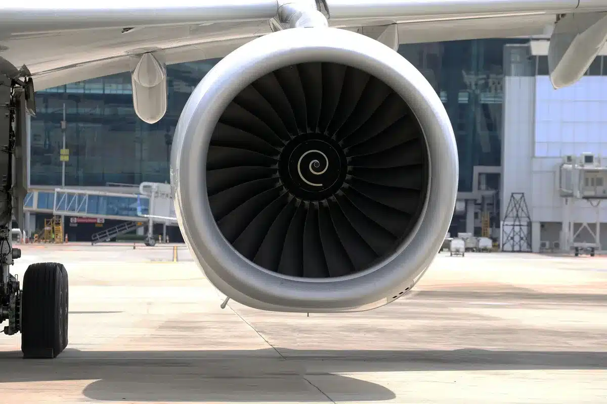 Aircraft wing interior with maintenance light visible near air conditioning unit