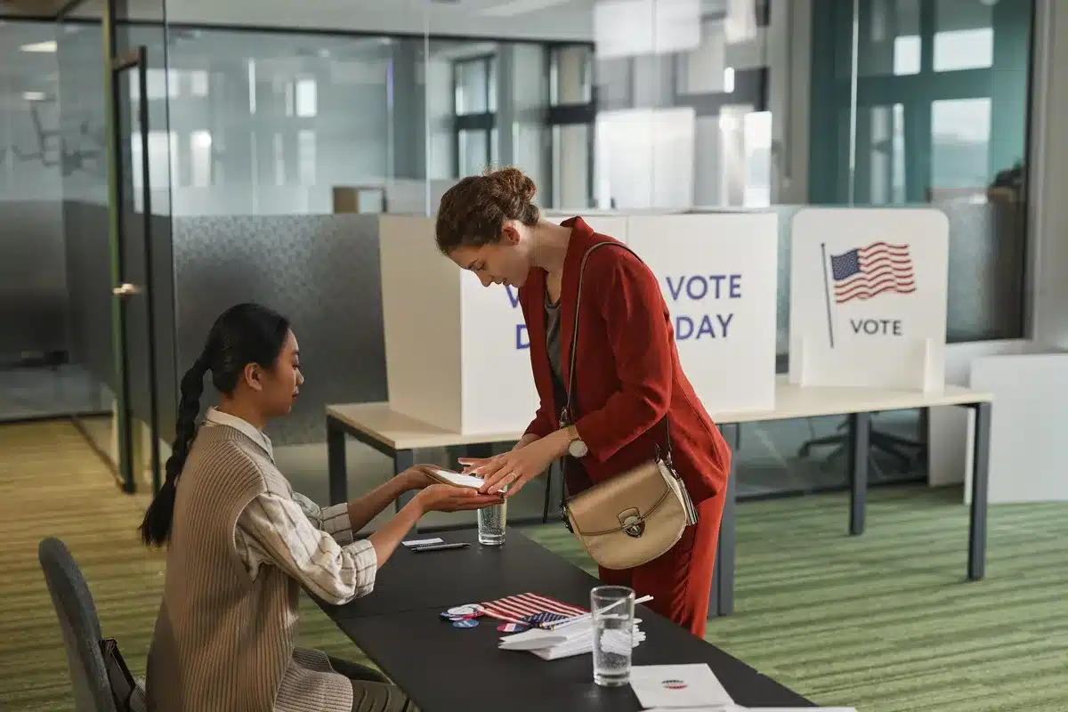 A voting booth with a South Carolina ballot visible, anonymous voter's hand inserting ballot into machine, fluorescent polling location lighting, quiet civic moment