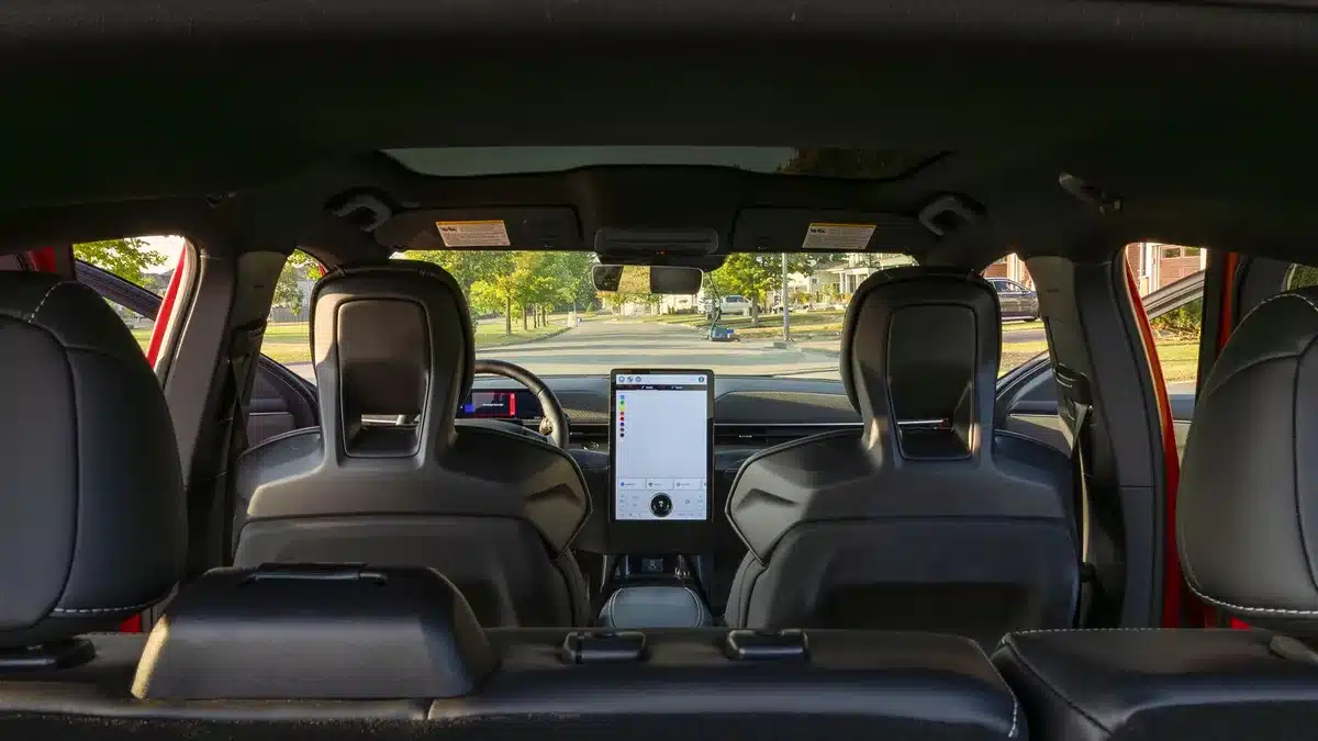 Modern electric SUV interior with minimalist dashboard design and large touchscreen display