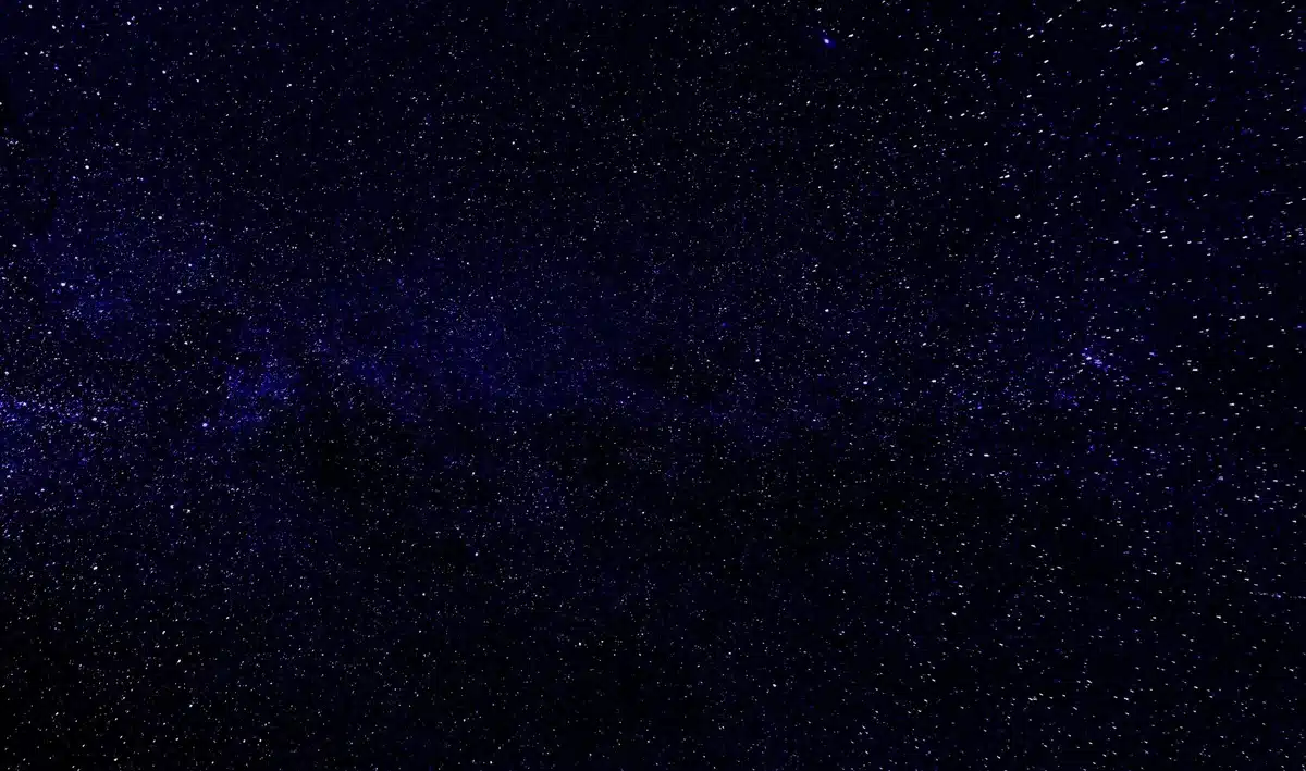 A wide-field view of distant galaxies and star clusters photographed through a telescope, showing the vast cosmic landscape that Roman will survey, with billions of stars and nebulae scattered across the frame.
