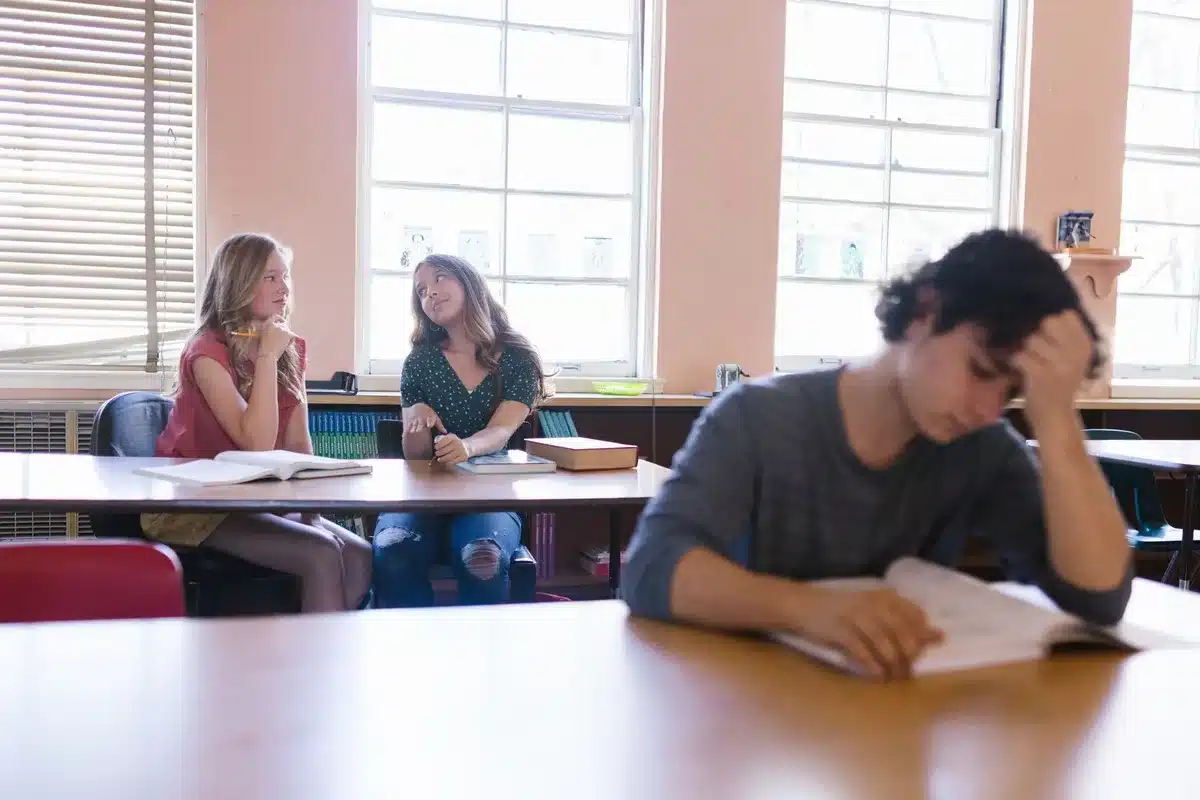 Students in a private school classroom with learning materials and technology, diverse group engaged in instruction