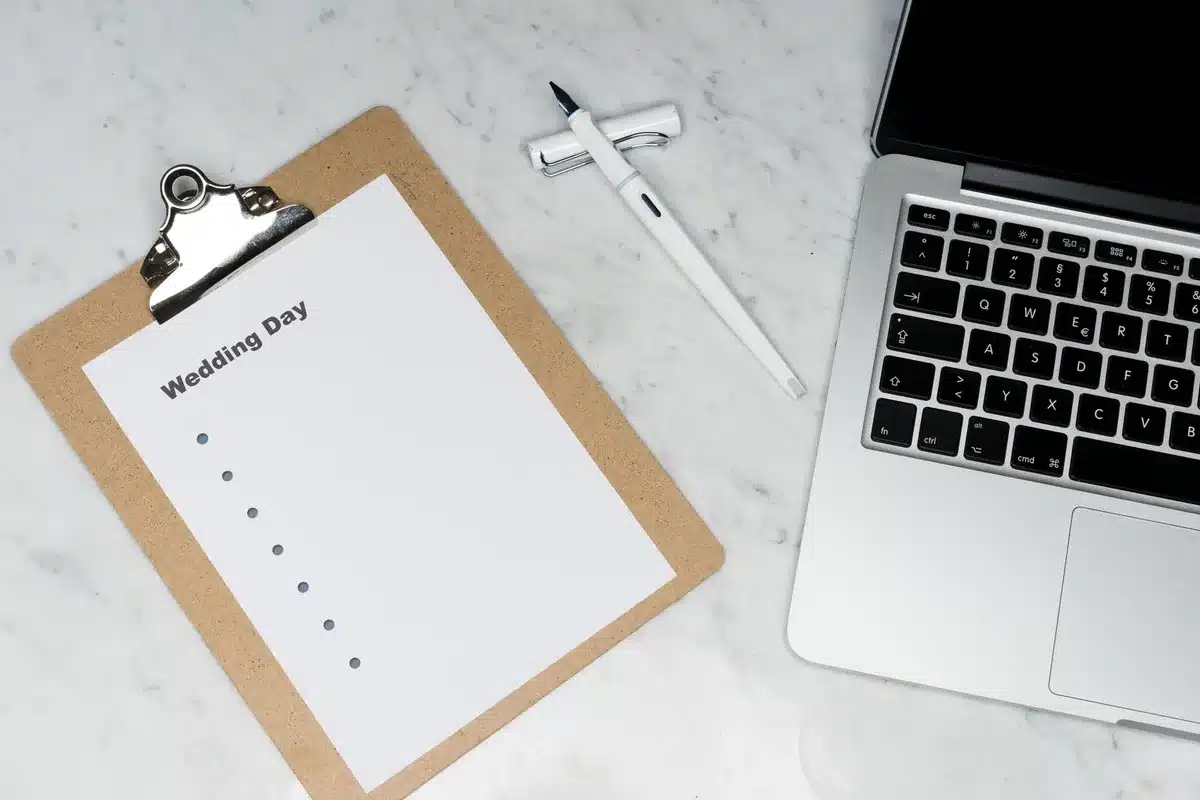A close-up of an open notebook with a pen resting on lined pages, soft focus background suggesting a newsroom or office environment