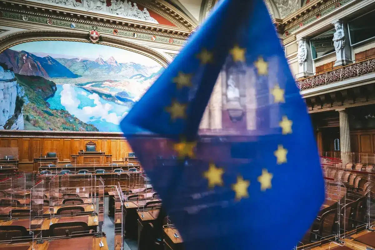 A formal Senate floor chamber with senators at their desks during voting, the chamber's classical architecture visible, a moment of legislative action on major foreign policy.