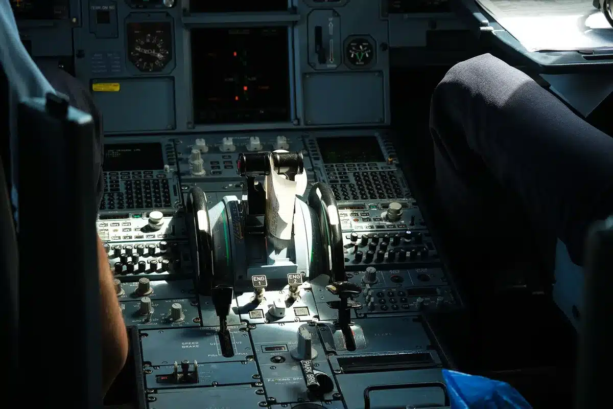 A military aircraft carrier deck with fighter jets preparing for launch, catapult steam rising, personnel in flight deck gear organizing weapons and ordnance