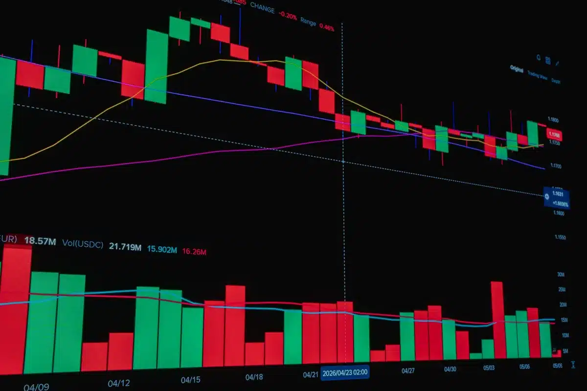 A glowing chart or graph trending upward on a dark screen, with financial data points and grid lines visible, representing revenue growth and margin expansion.