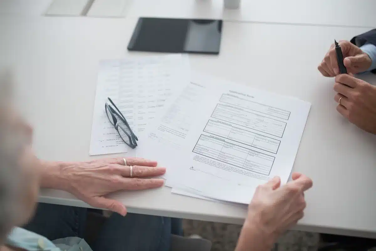 An official Social Security Administration document or notification letter on a desk with reading glasses and a calculator nearby, symbolizing benefit calculations and financial planning for retirees.