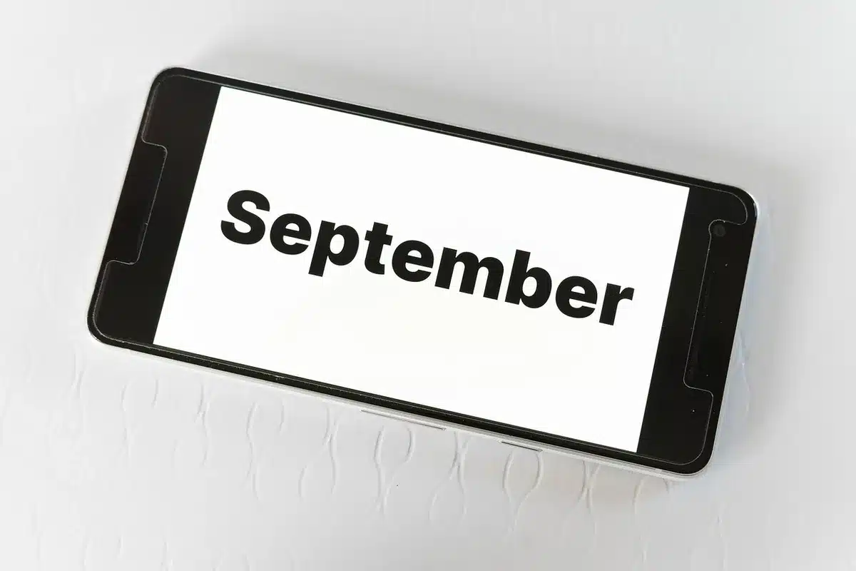 A calendar page showing September 2026 with four highlighted Wednesdays in different colors, each marked with a dollar sign symbol and birth date ranges, representing the staggered payment schedule