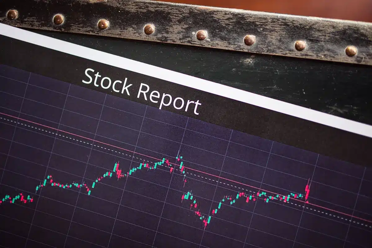 A stock market screen displaying an upward trending line graph in green, with financial data and ticker symbols blurred in the background, representing a positive earnings reaction