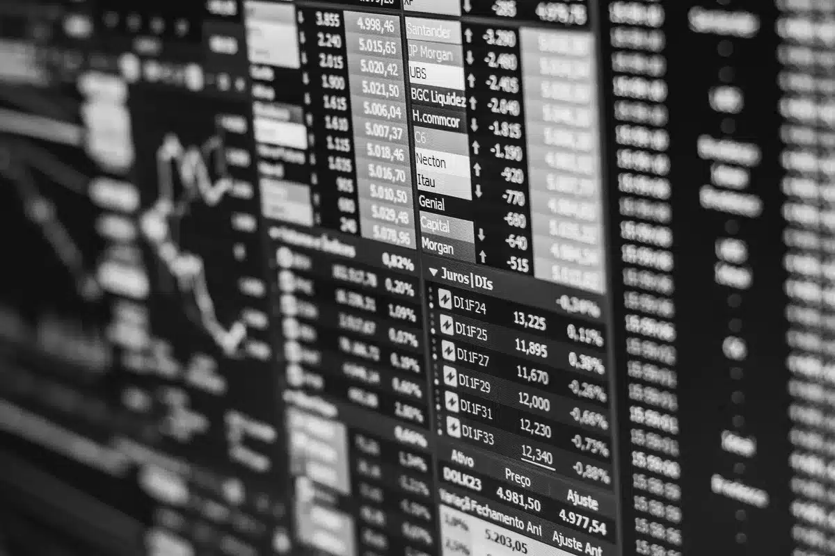 A sleek technology company headquarters or trading floor with multiple screens showing financial data and charts, bathed in professional lighting with a focus on the intensity of market activity and decision-making.