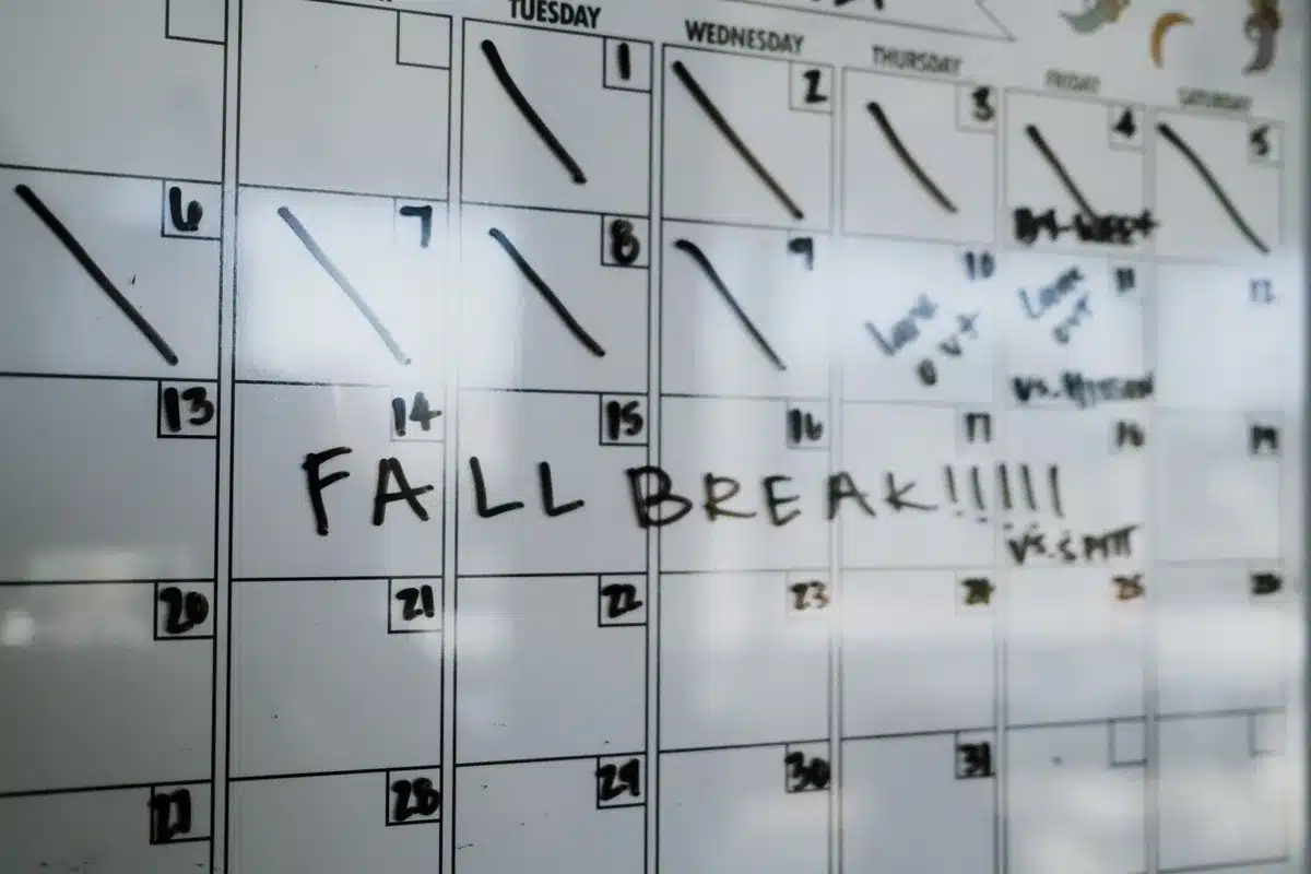 A calendar page showing July 31 highlighted in bold with a payment notification symbol, August 1 appearing as a Saturday, and a bank deposit receipt visible in soft focus, symbolizing the early payment arrival