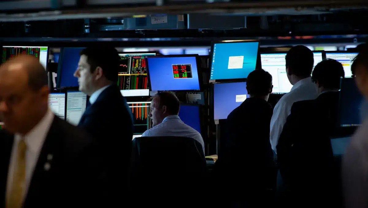 Trading floor with screens showing market indices during volatile session | stock market volatility trading floor
