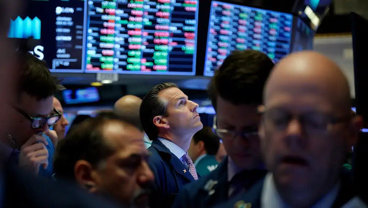 Traders reacting to earnings announcements on screens showing stock tickers | earnings reaction trading floor