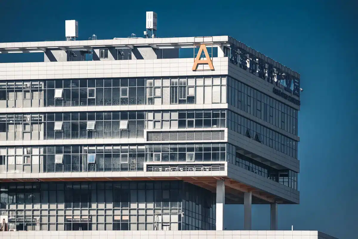Amazon headquarters building exterior at dusk with company logo visible, glass and steel architecture, ambient evening lighting
