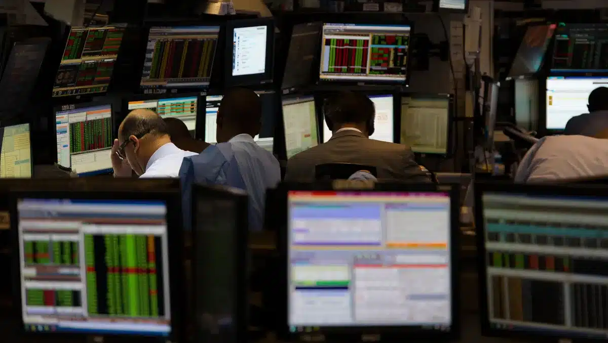 Stock market trading floor with glowing screens and price tickers, anonymous traders monitoring data | stock market trading floor