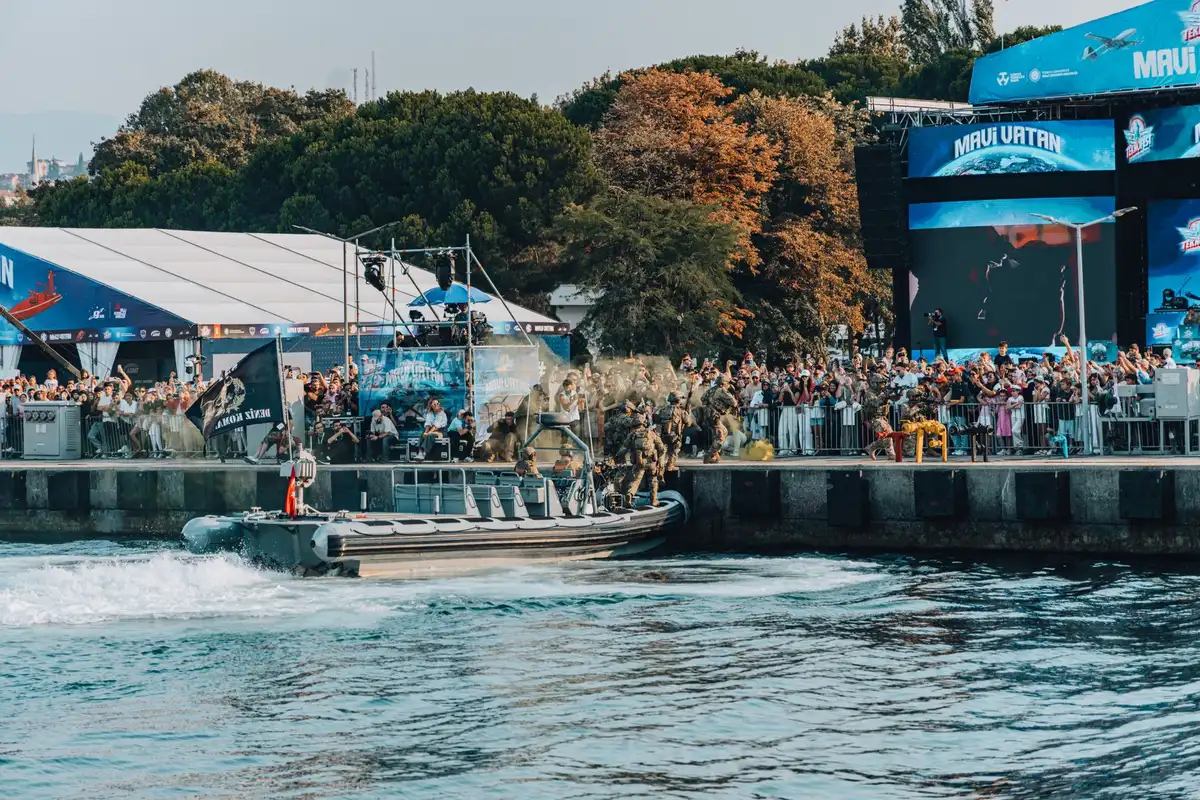 Naval minesweeping vessel with sonar equipment deployed in shallow waters, underwater drones visible on deck scanning the seafloor, military personnel monitoring screens, clear sunny day, calm waters