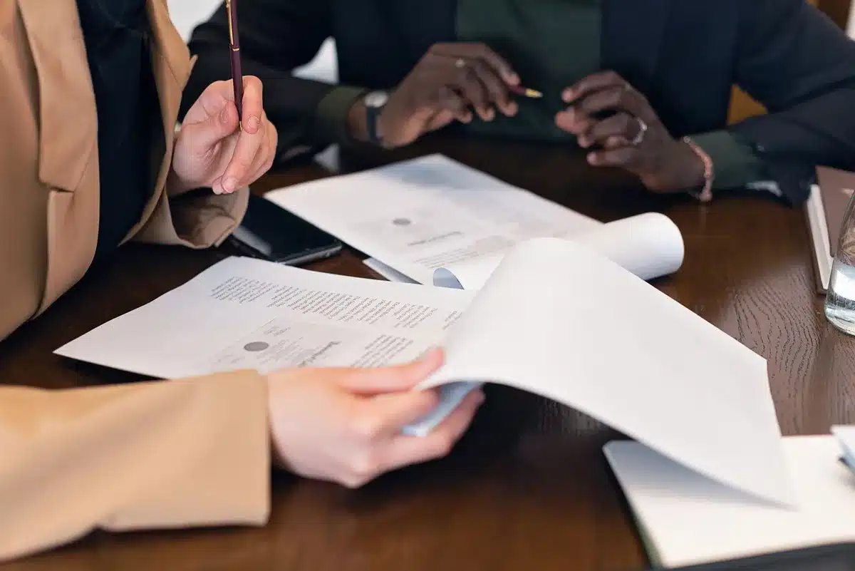 Federal student loan documents and payment forms on a desk with calculator and pen