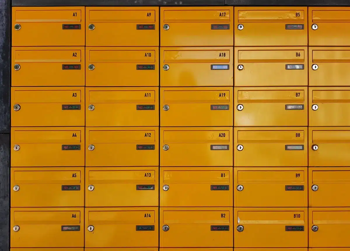 A mail sorting facility with postal workers at sorting machines, envelopes moving along conveyor belts, representing USPS operations and mail ballot logistics.