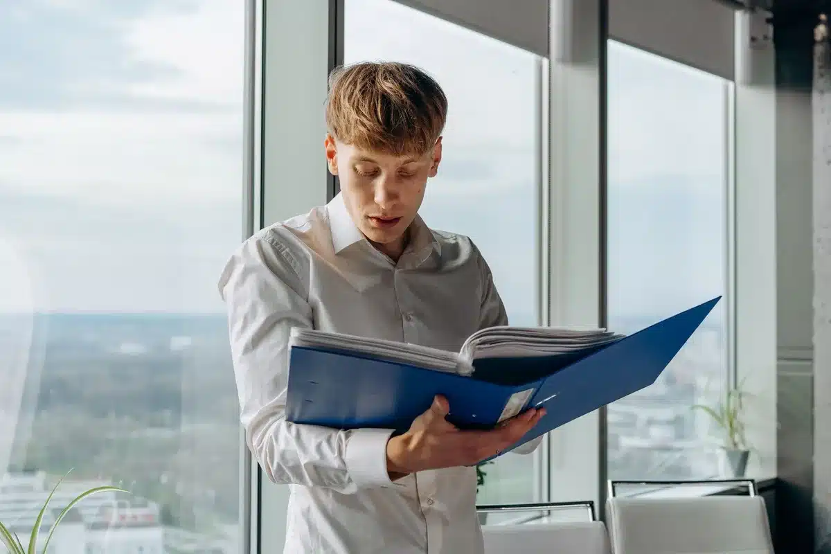 A T-Mobile corporate office or headquarters meeting room with a manager reviewing in-store customer service metrics on a screen, professional environment, neutral lighting