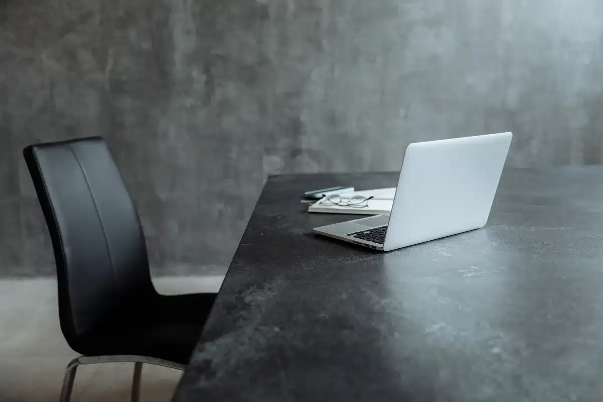 A campaign office or headquarters with blank whiteboards and empty desks, a single discarded campaign button on a desk, overcast window light