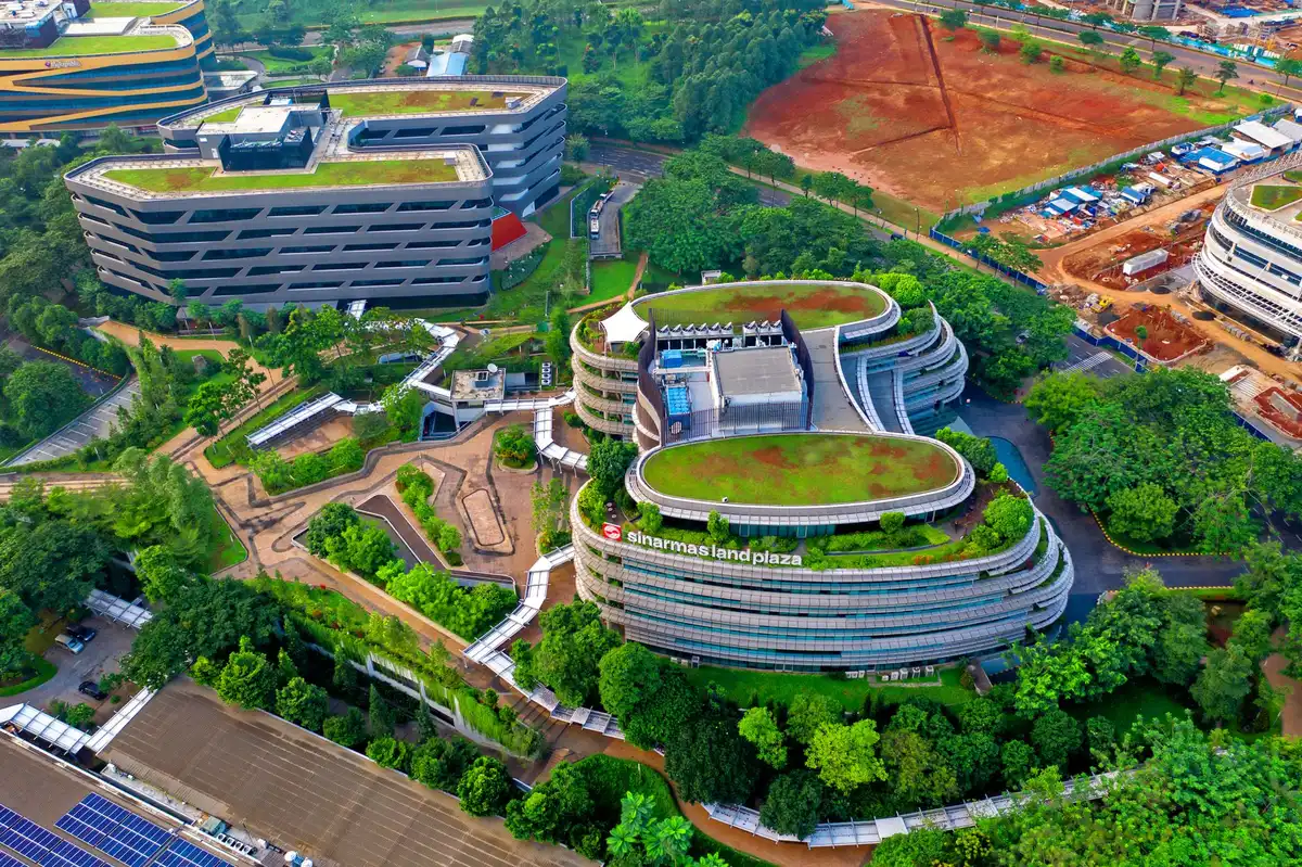 Apple's Cupertino campus gleaming in afternoon sunlight, reflecting the company's growth and innovation hub status, architectural curves and glass, empty plaza suggesting scale and legacy.