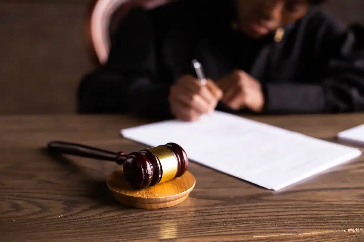 Courtroom interior, judge's bench and jury box, wooden furniture, professional legal setting, daytime natural light, formal and serious atmosphere
