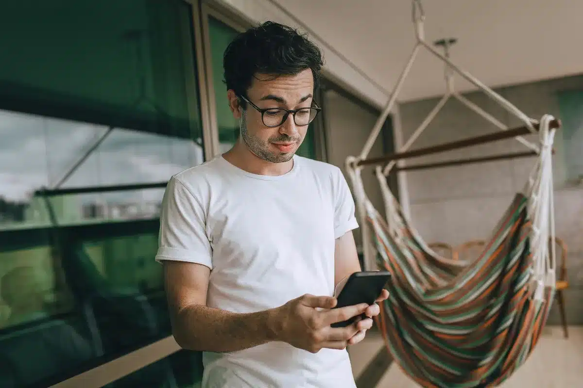A voter looking at a polling result on a phone screen, concerned expression visible, blurred polling numbers in background, warm indoor lighting