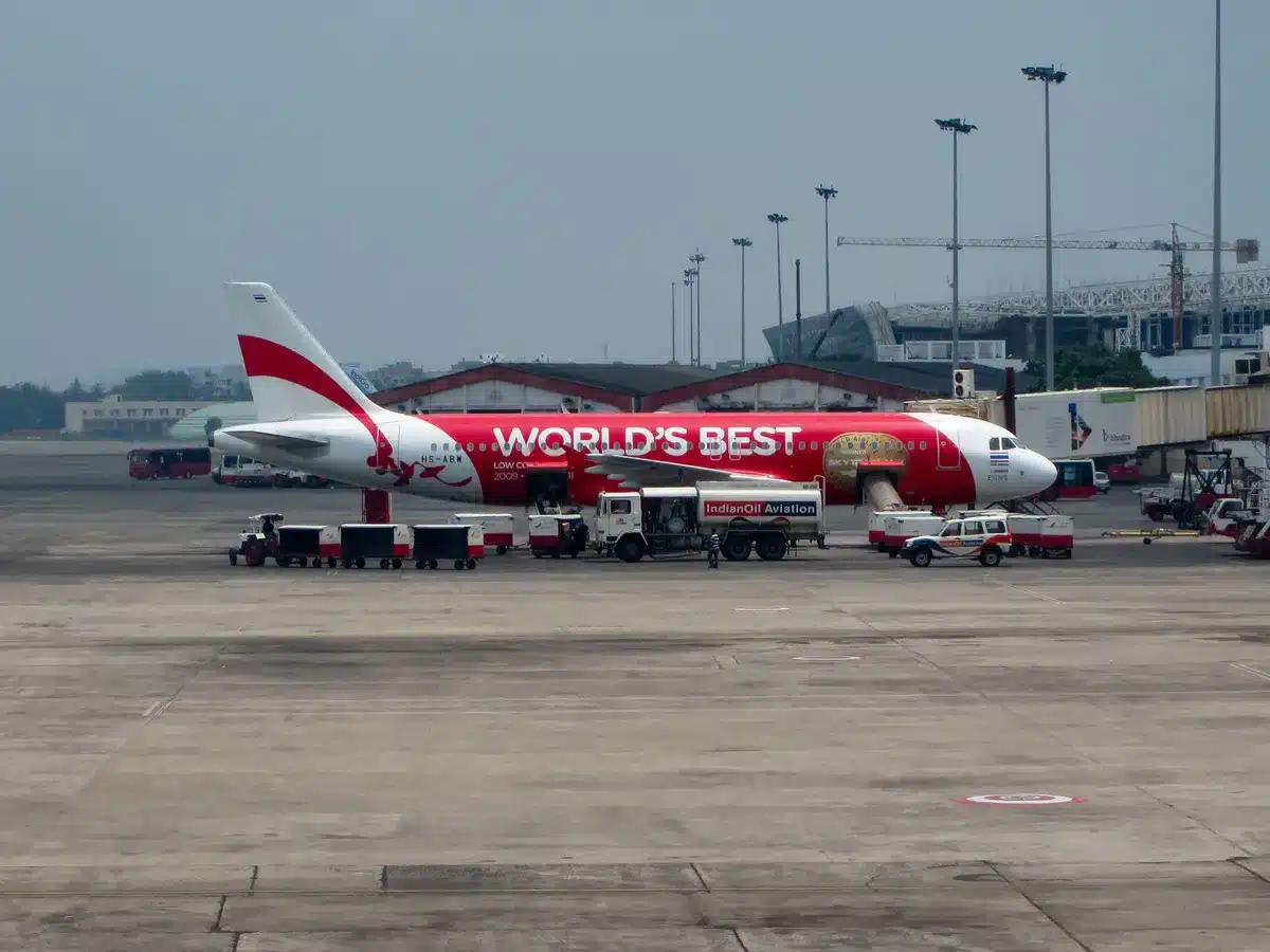 Ankara airport tarmac with presidential aircraft, catering truck elevated to aircraft-door level, media boarding in background, security perimeter visible