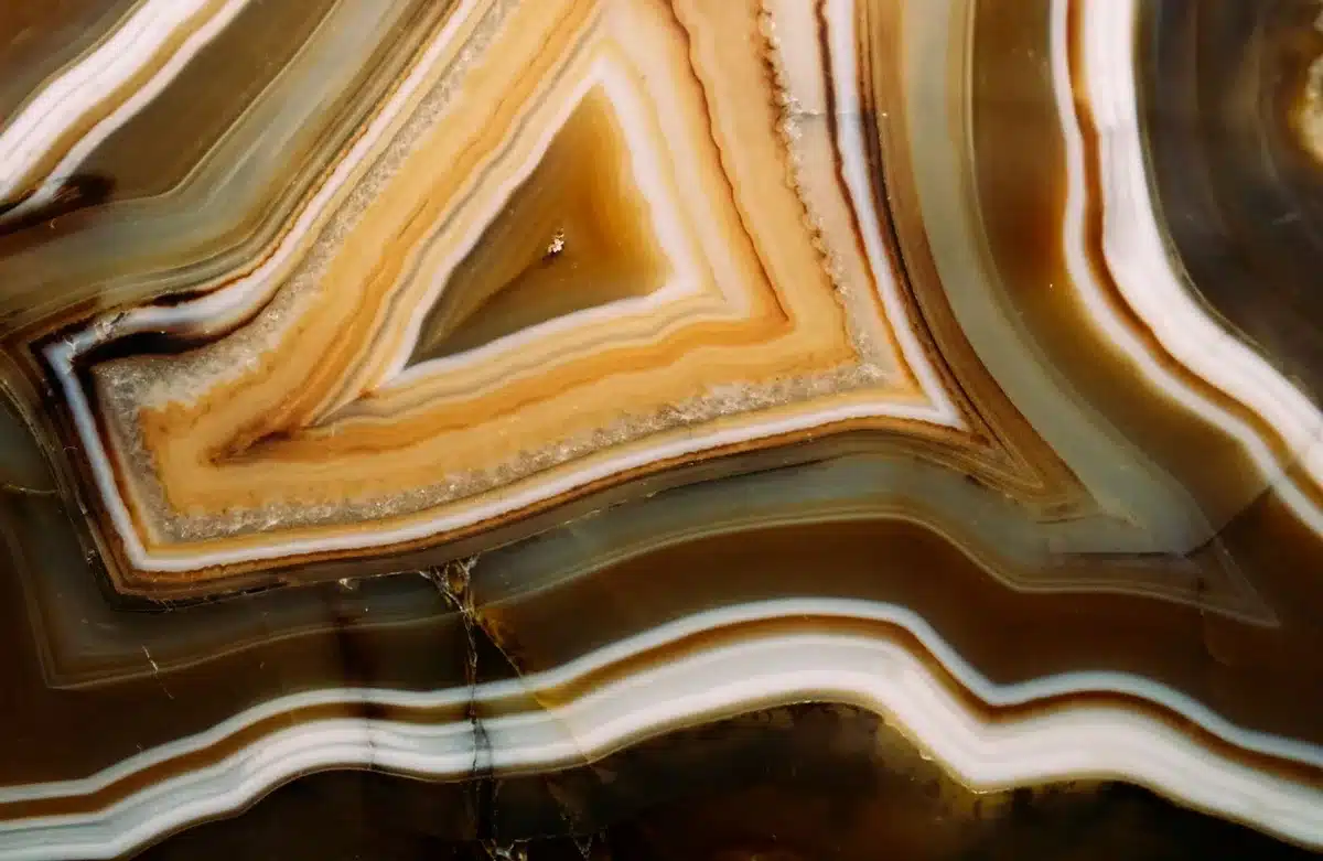 Rare-earth mineral crystals under laboratory lighting, close-up of geometric mineral formations, scientific specimen photography