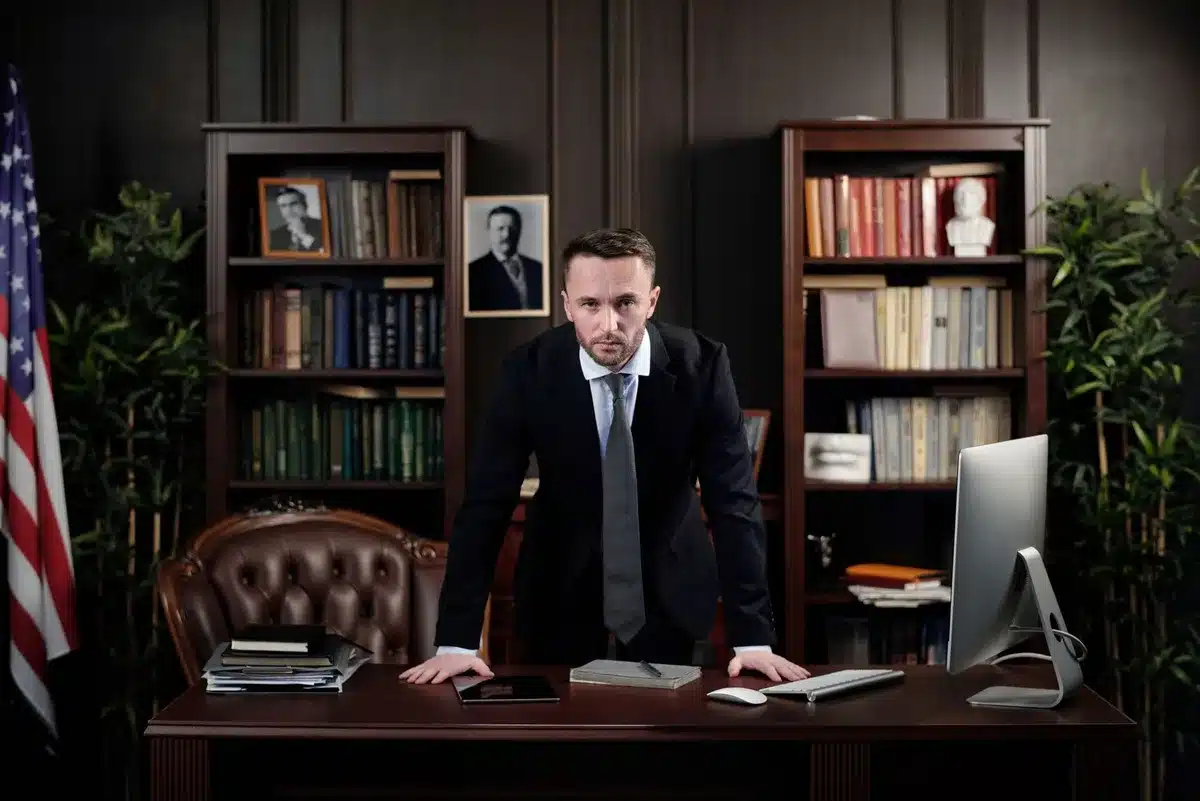 A diplomatic negotiation table with papers, phones, and national flags in shadow, tension evident in the sparse setting