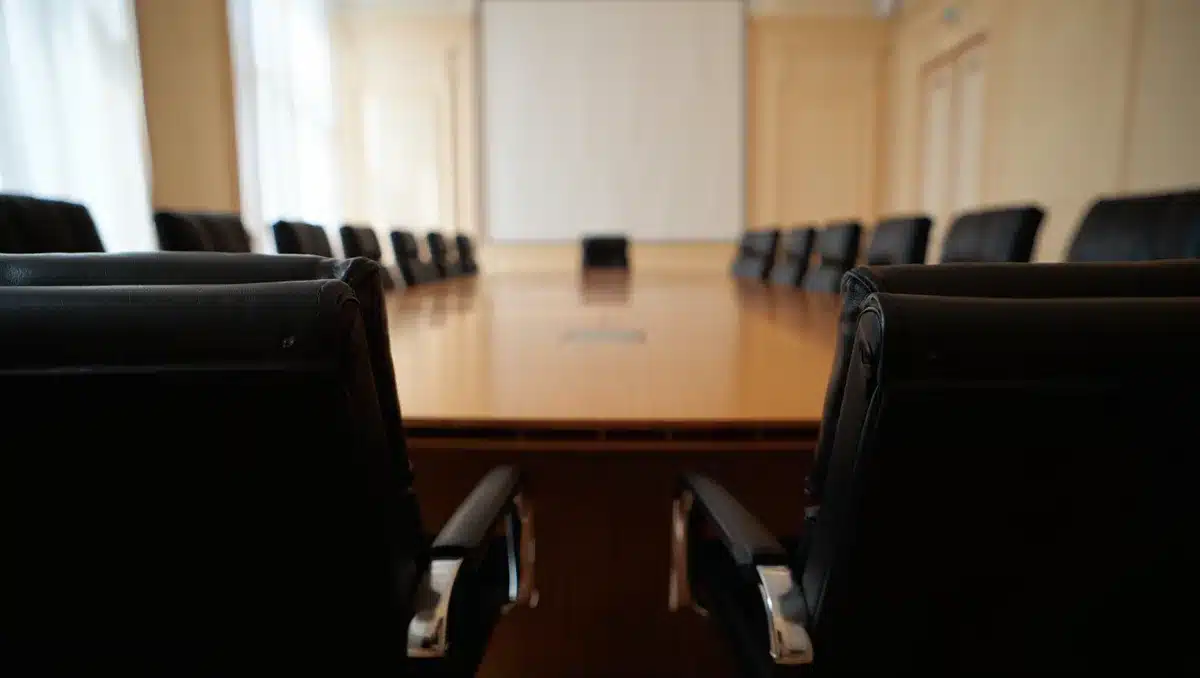 Empty negotiation table with chairs facing each other | diplomatic talks setting