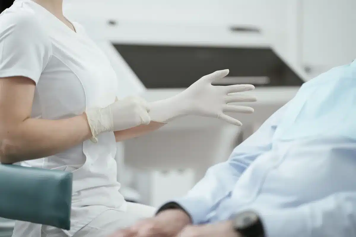A White House medical examination room with a scale, blood pressure cuff, and stethoscope on a clinical desk under soft overhead lighting