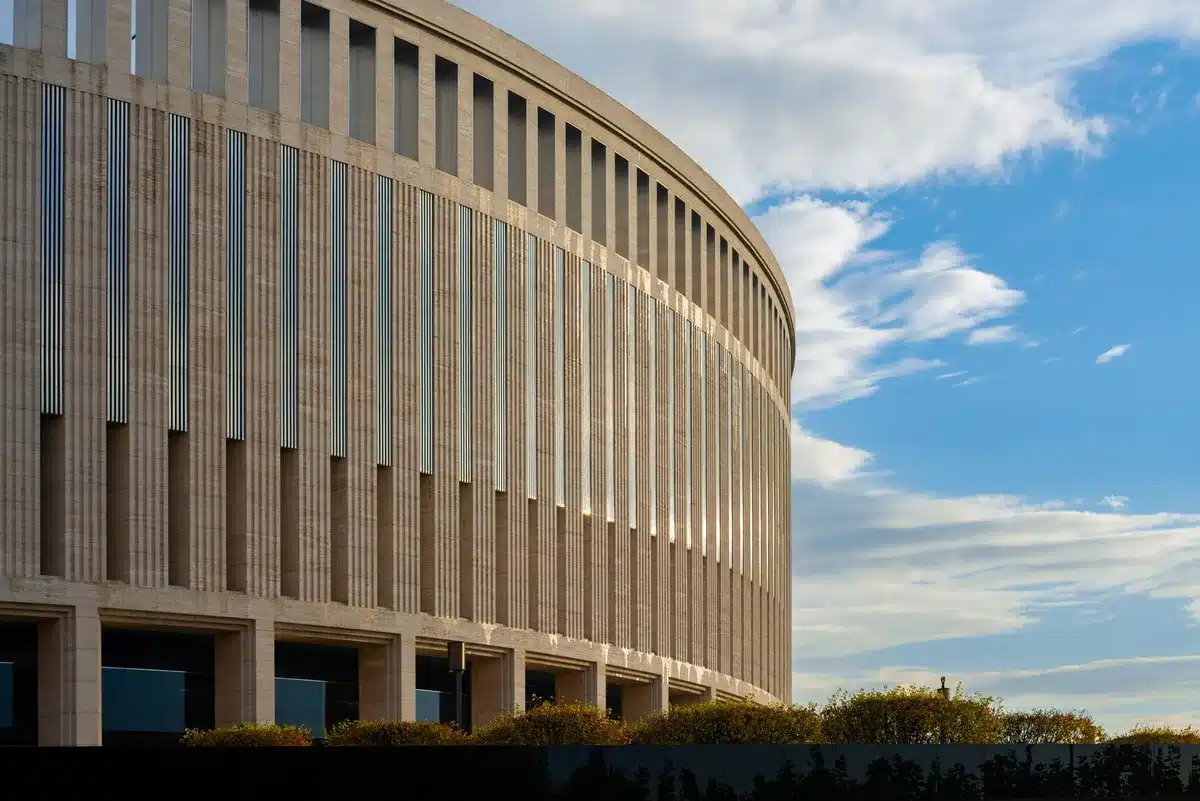 The Kennedy Center exterior in Washington, D.C., with scaffolding and renovation equipment visible, interior spaces under construction, architectural details being restored, work crews in hard hats moving through corridors