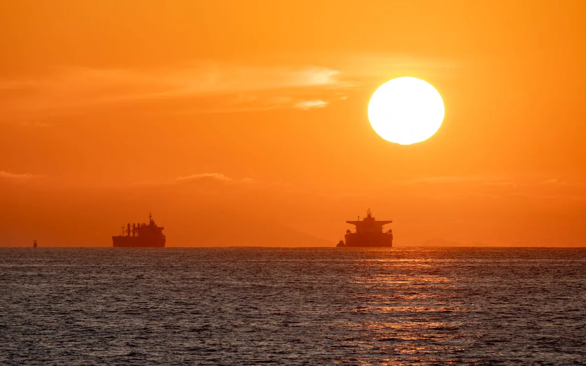 Oil tanker in shipping lane with distant coastline