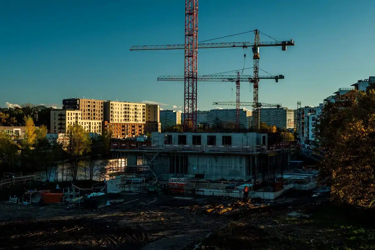 Construction site with cranes and scaffolding visible against the White House backdrop, halted mid-project, a blocked entrance sign visible.