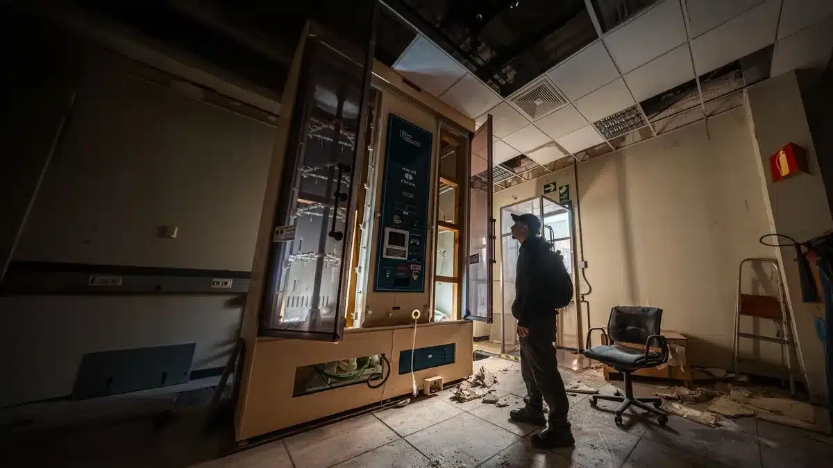 An empty campaign office space with discarded signs and materials scattered on a desk, a single phone off the hook, morning light filtering through windows